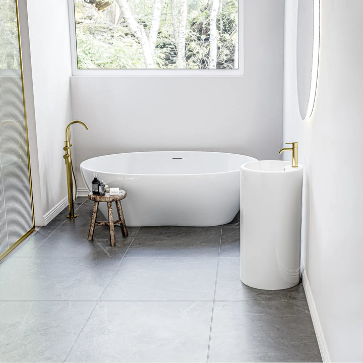 White freestanding pedestal sink with gold faucet, compact design