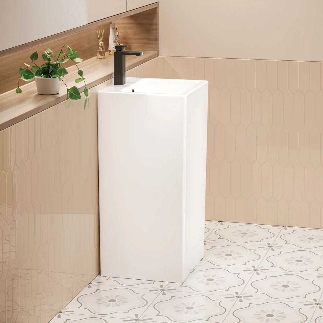 Glossy white ceramic tall rectangular freestanding pedestal sink with matte black single lever faucet