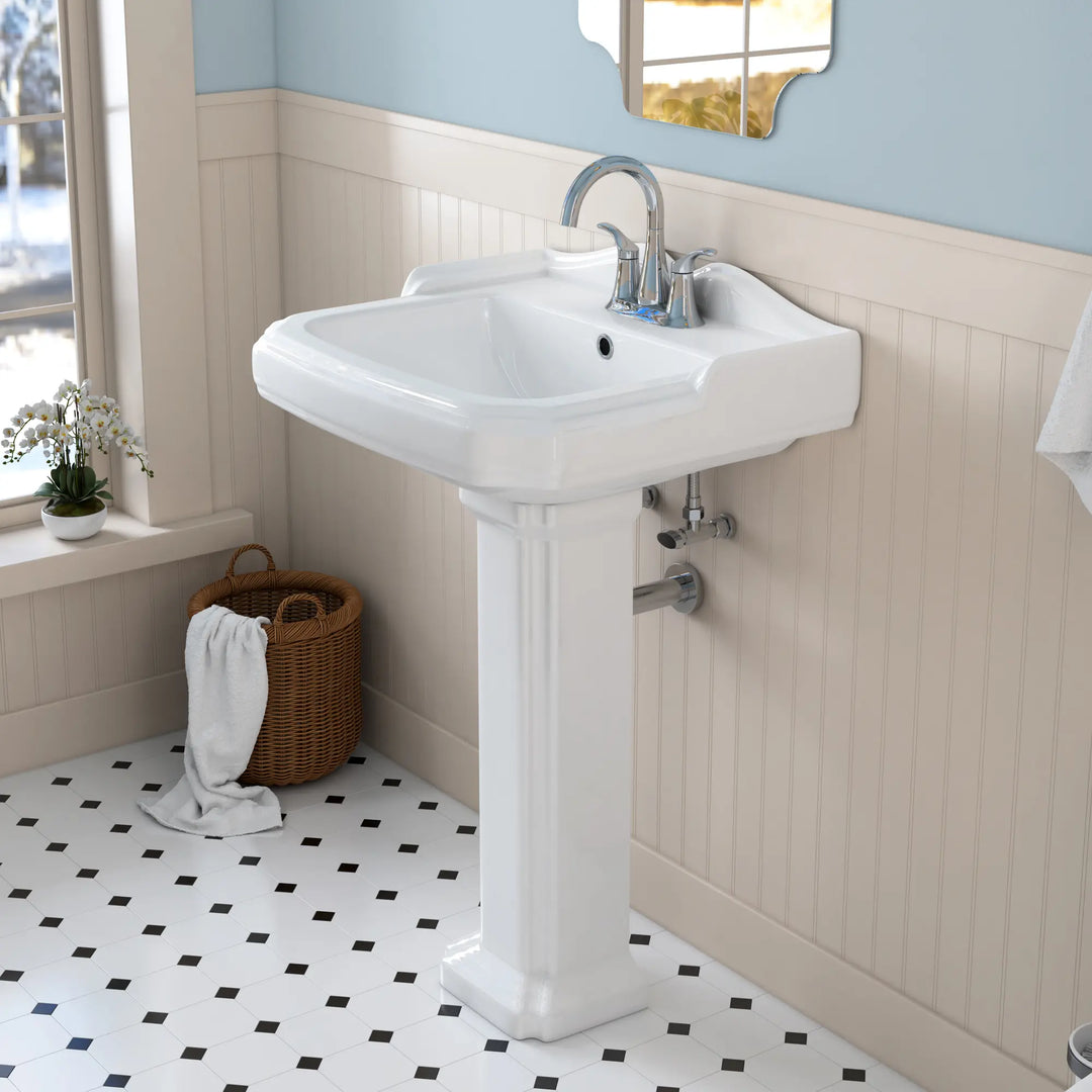 White ceramic pedestal sink with chrome centerset faucet.