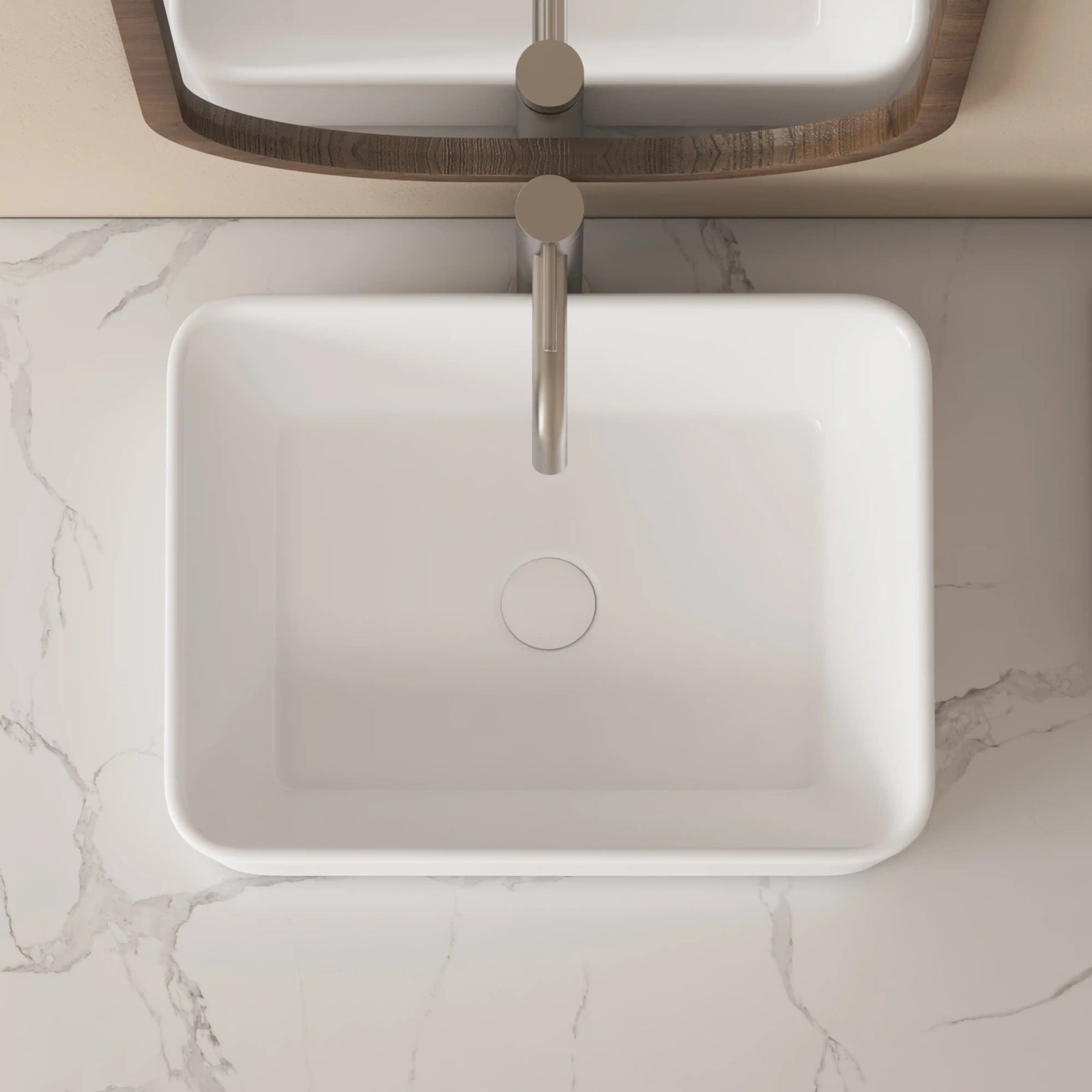 Top view of a white ceramic rectangular vessel sink with rounded corners.