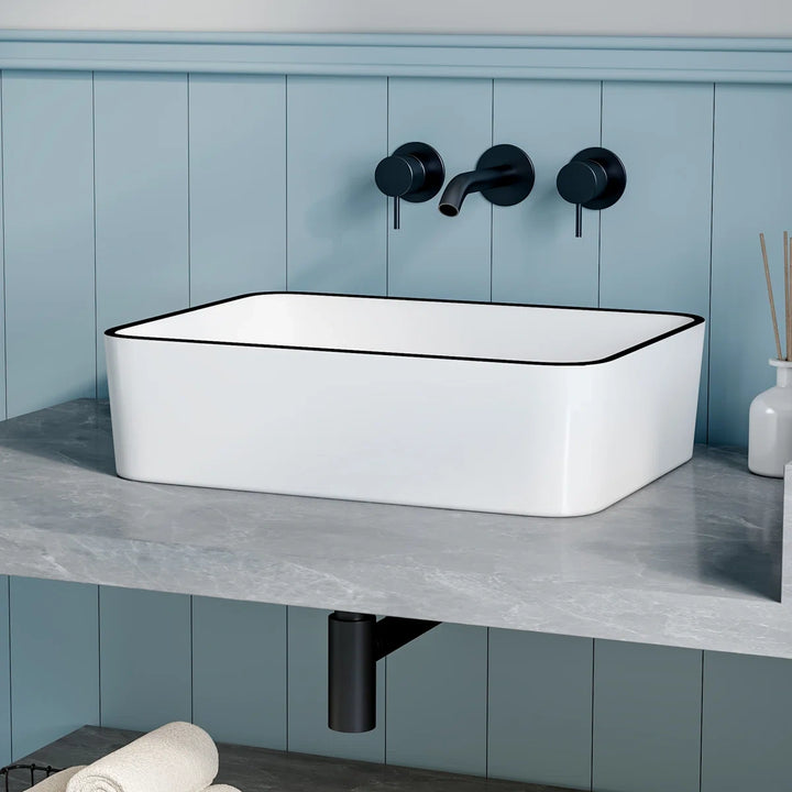 White rectangular vessel sink with modern black rim design.