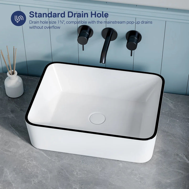 Black rimmed white sink with standard 1.75 inch drain hole.