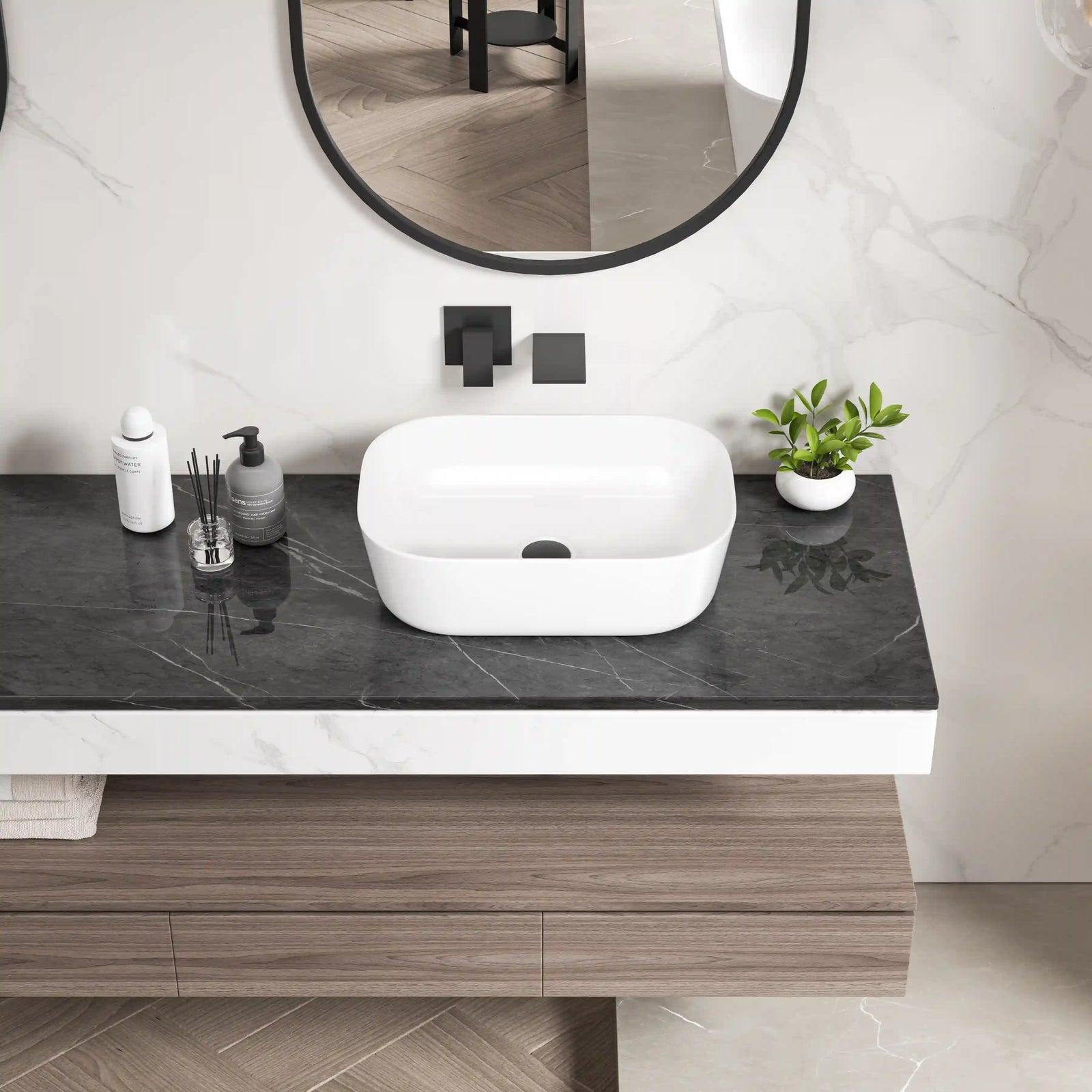 Modern white ceramic rounded square vessel sink on marble countertop.#color_white