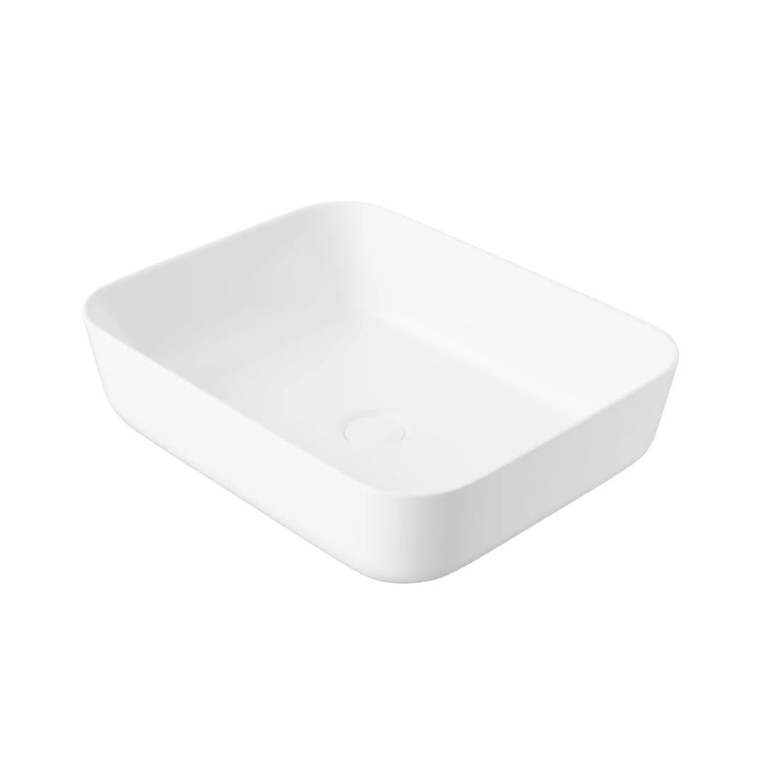 White matte rounded rectangular ceramic vessel sink with central drain hole