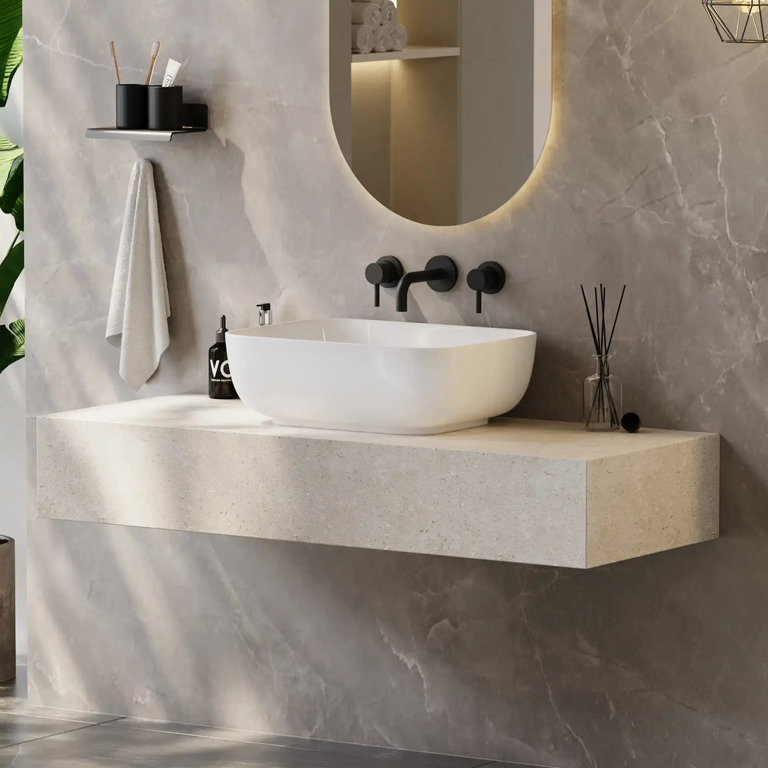 White rounded rectangular solid surface vessel sink matched with matte black wall-mounted bathroom faucet