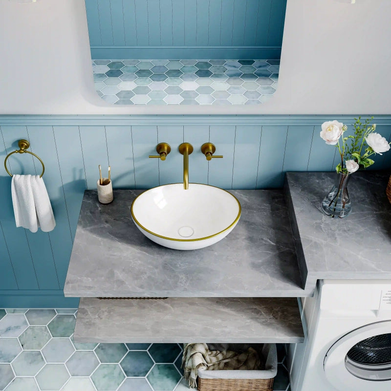 Glossy white oval ceramic vessel sink with thin gold rim border