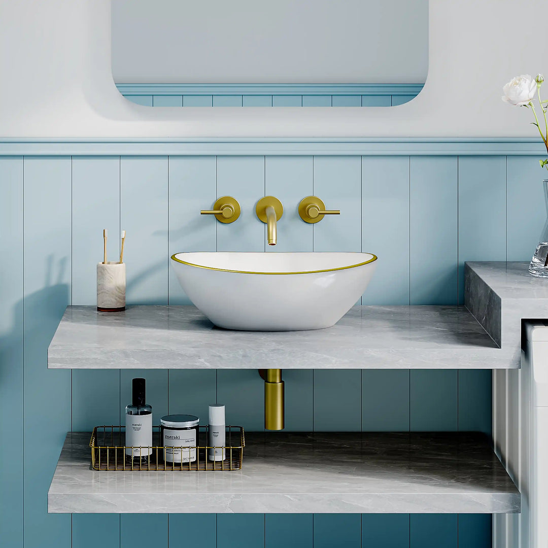 Glossy white oval ceramic vessel sink with thin gold rim border