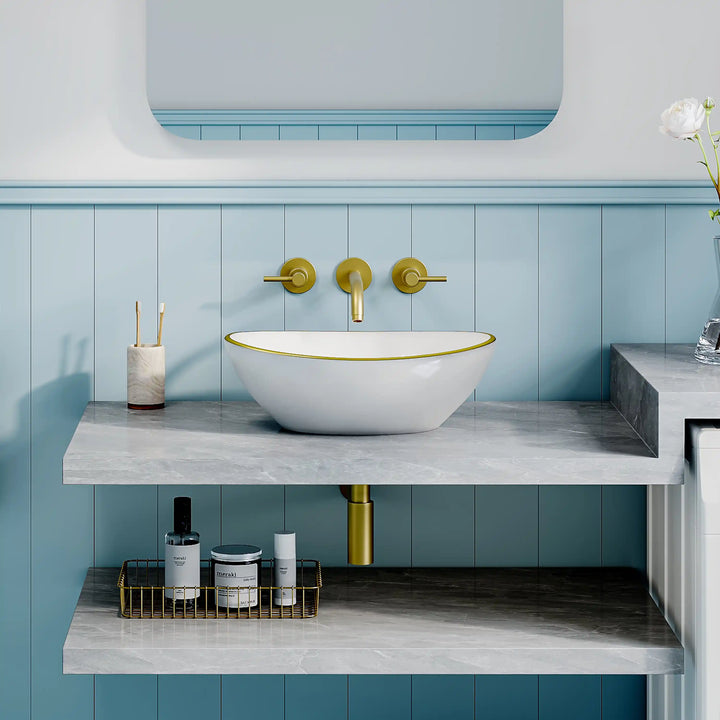 Glossy white oval ceramic vessel sink with thin gold rim border