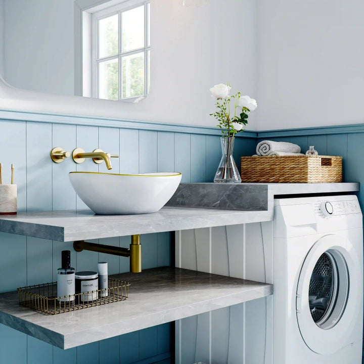 Glossy white oval ceramic vessel sink with thin gold rim border