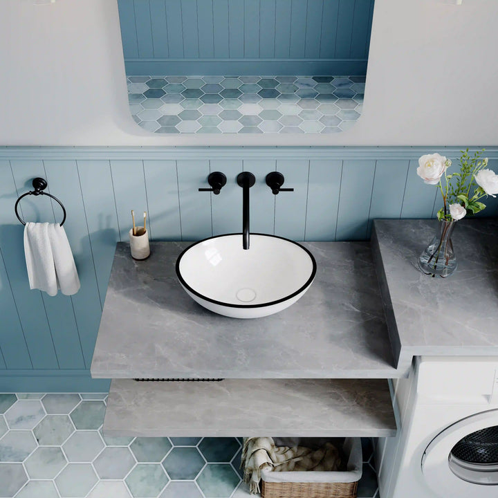 White ceramic oval vessel sink with thin black rim border, modern countertop wash basin