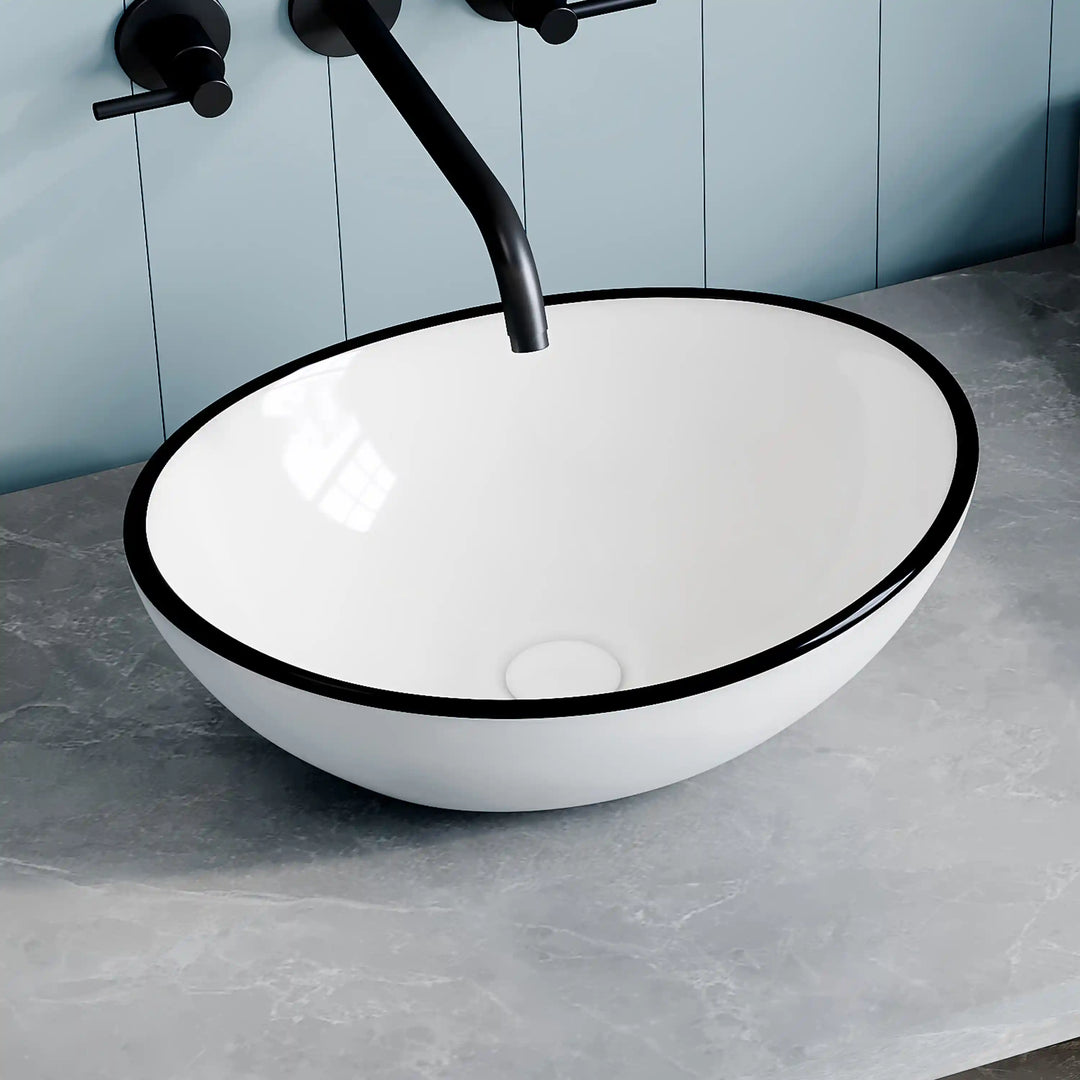 White ceramic oval vessel sink with thin black rim border, modern countertop wash basin
