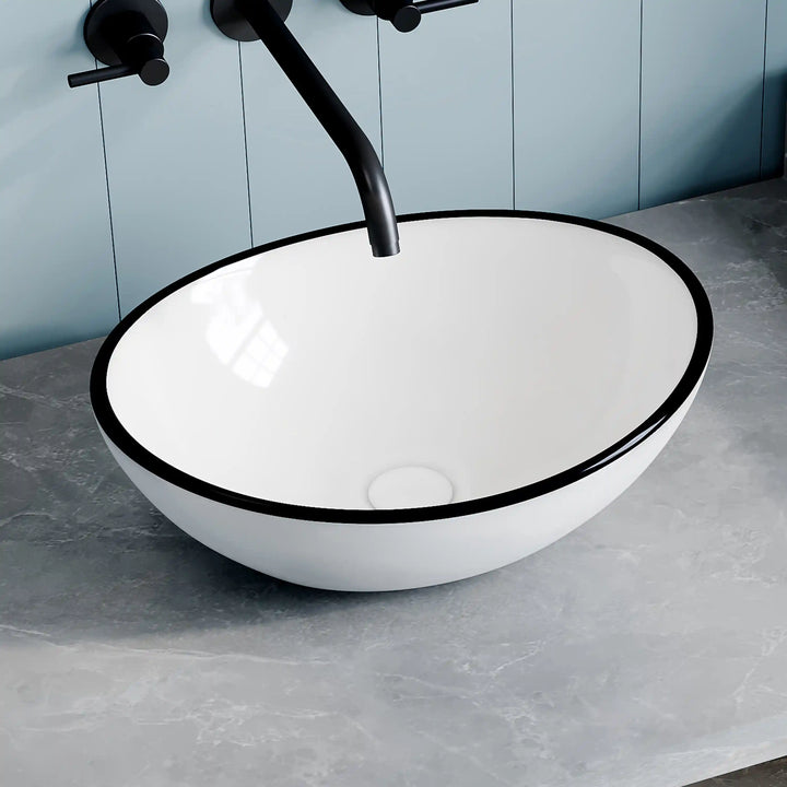 White ceramic oval vessel sink with thin black rim border, modern countertop wash basin