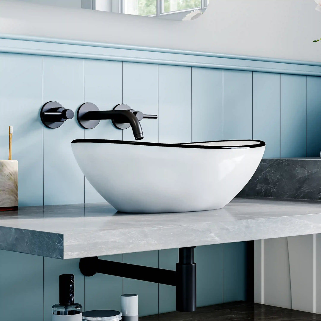 White ceramic oval vessel sink with thin black rim border, modern countertop wash basin