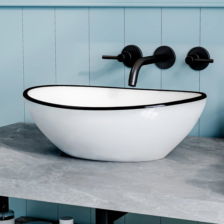 White ceramic oval vessel sink with thin black rim border, modern countertop wash basin
