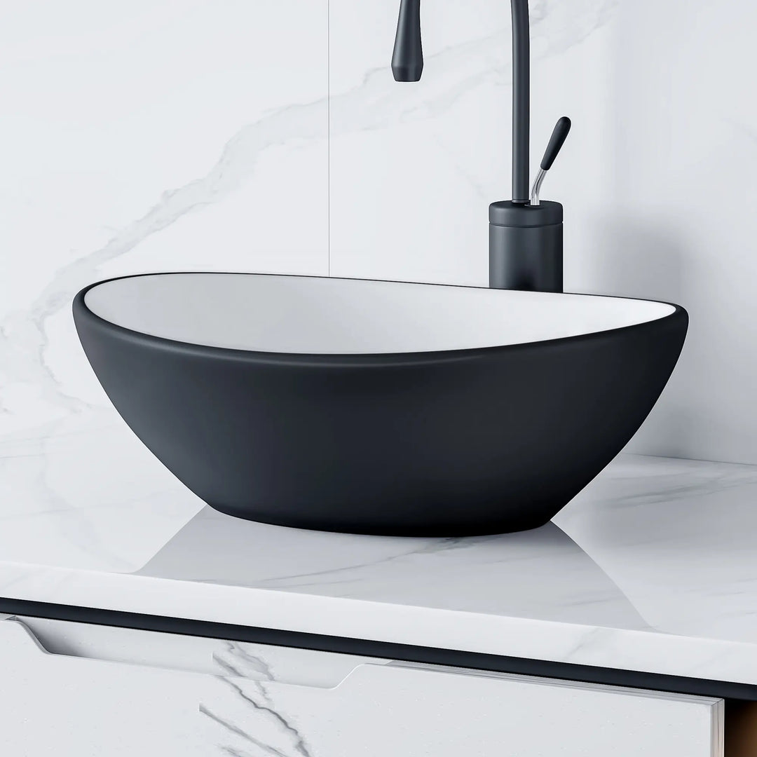 Matte black and white oval ceramic vessel sink