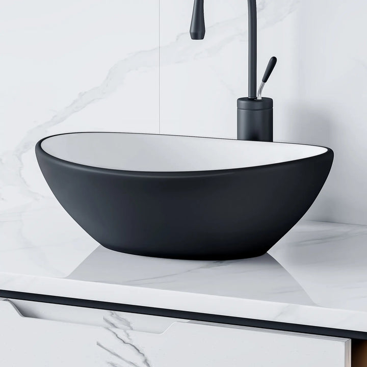 Matte black and white oval ceramic vessel sink