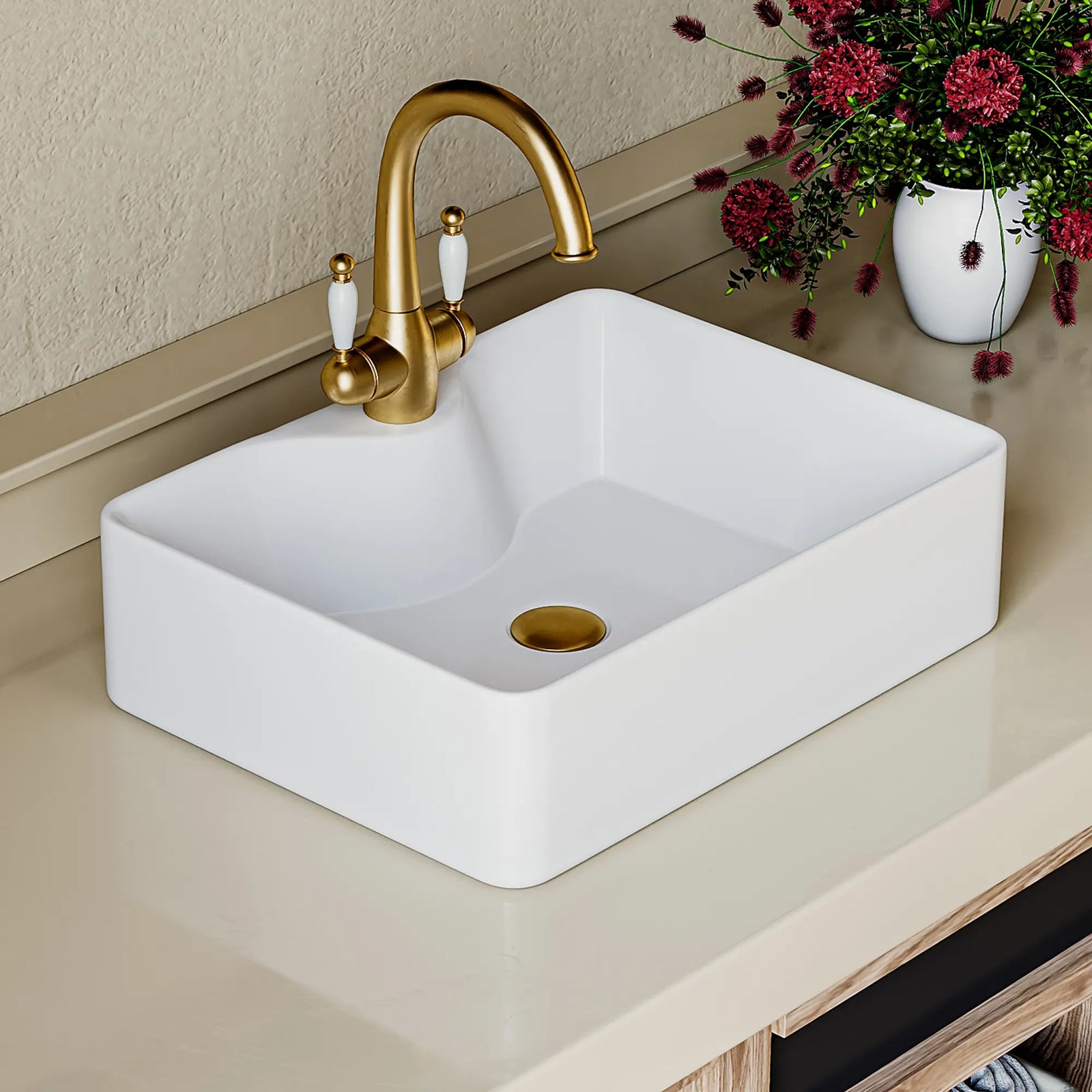 White rectangular ceramic vessel sink with gold faucet and drain.