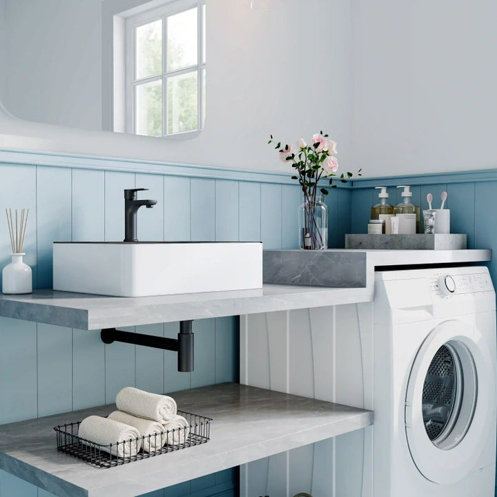 White ceramic square countertop vessel sink with black thin edge trim, paired matte black faucet