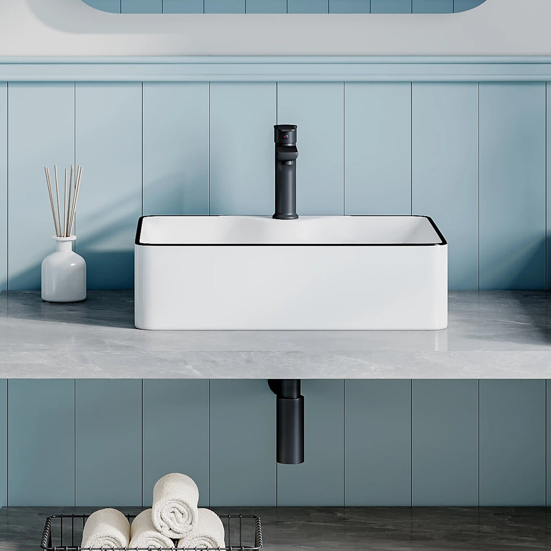 White ceramic square countertop vessel sink with black thin edge trim, paired matte black faucet