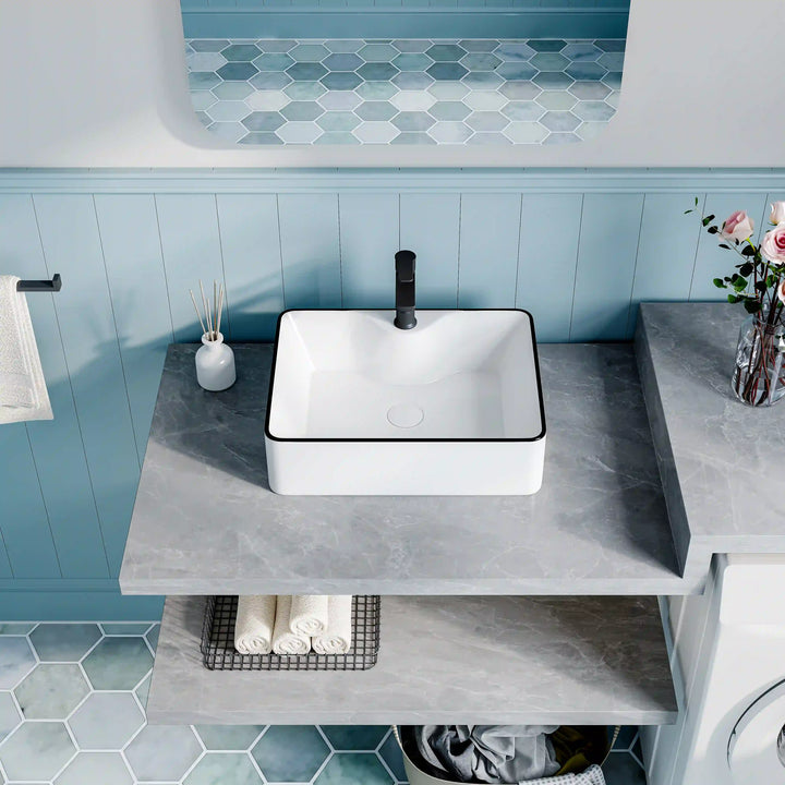 White ceramic square countertop vessel sink with black thin edge trim, paired matte black faucet
