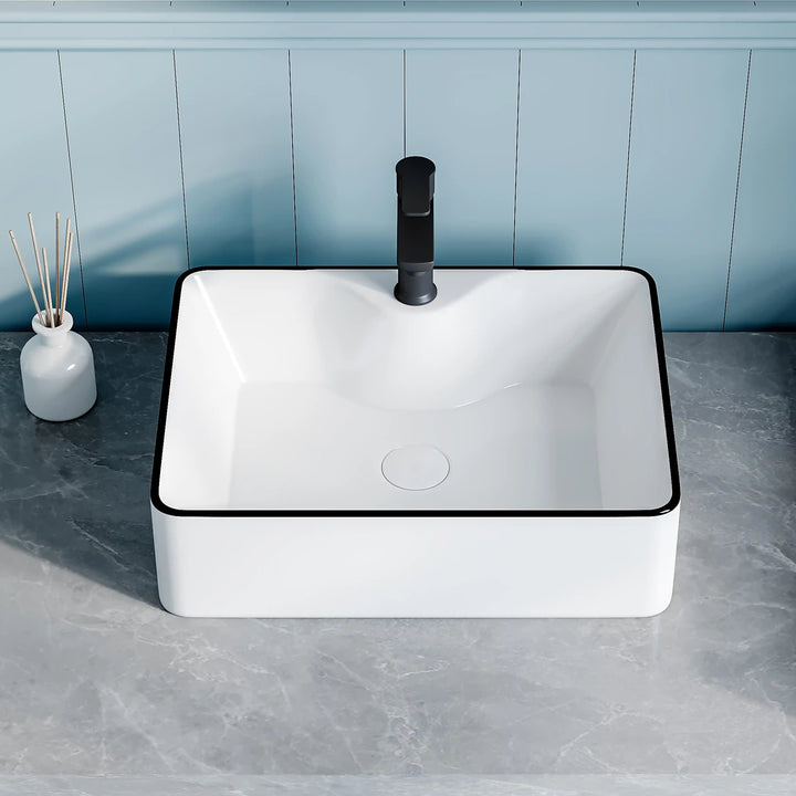 White ceramic square countertop vessel sink with black thin edge trim, paired matte black faucet