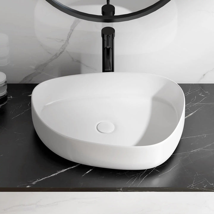 White matte oval ceramic countertop vessel sink with hidden pop-up drain, modern bathroom wash basin