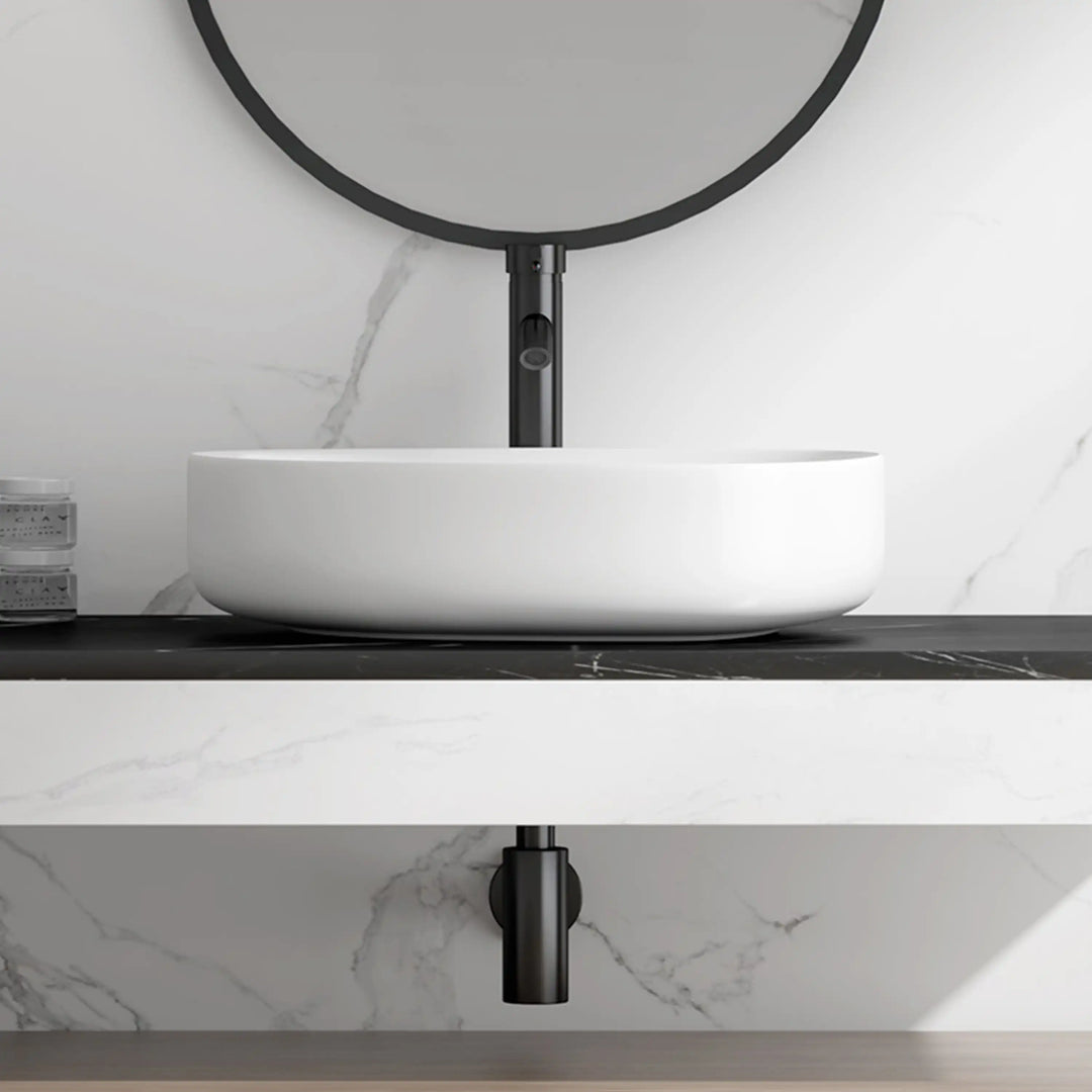 White matte thickened oval ceramic vessel sink, minimalist curved countertop wash basin side view