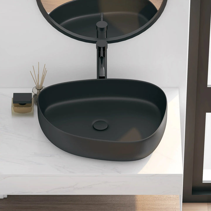 Matte black solid surface oval vessel bathroom sink