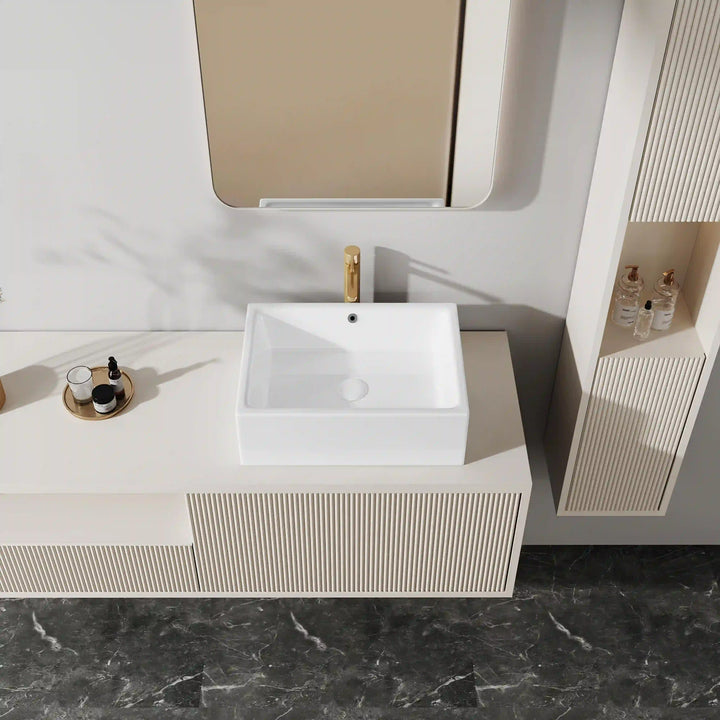 White rectangular ceramic countertop vessel sink with gold tall faucet