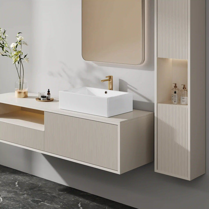 White rectangular ceramic vessel sink paired with brushed gold tall faucet