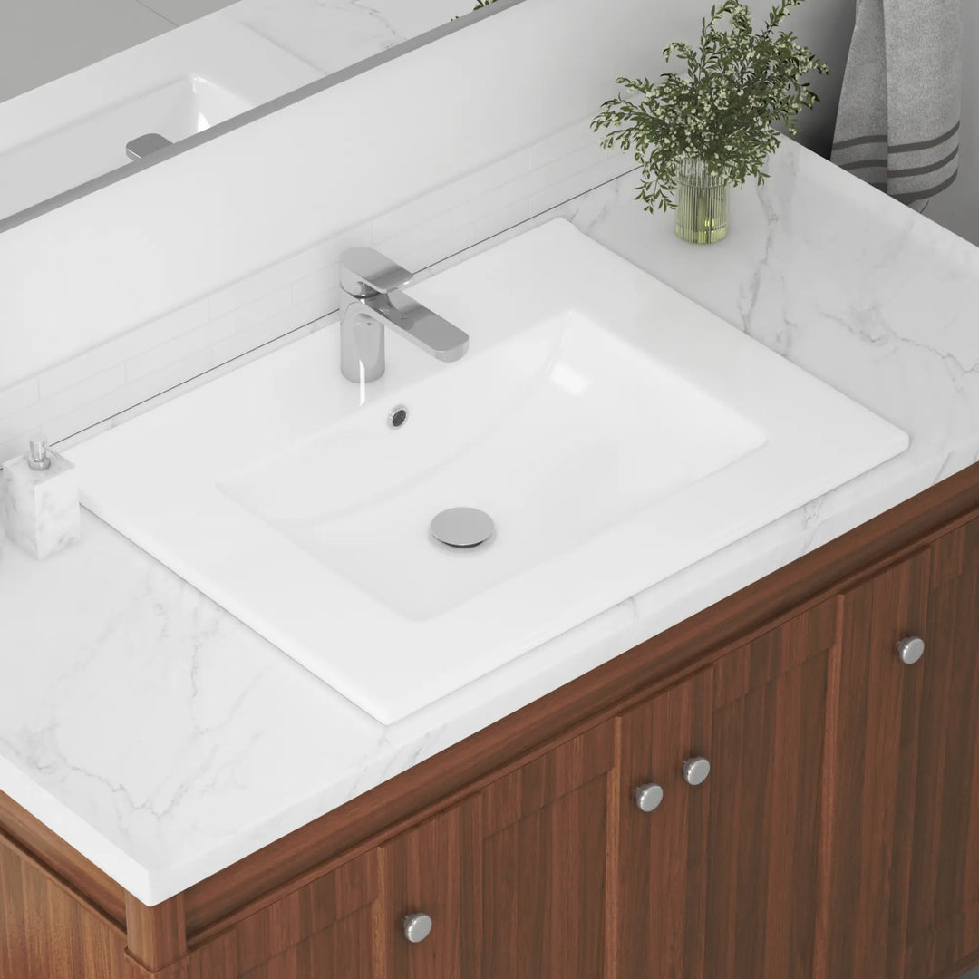 White rectangular vanity sink with single faucet hole and chrome drain.