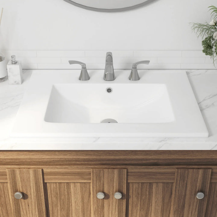 White ceramic rectangular bathroom sink with 3-hole chrome faucet.