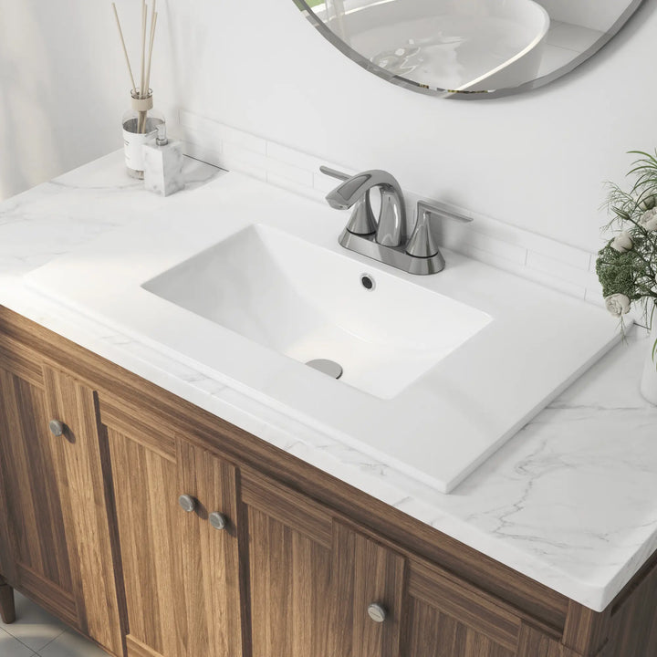 White ceramic rectangular vanity sink with faucet