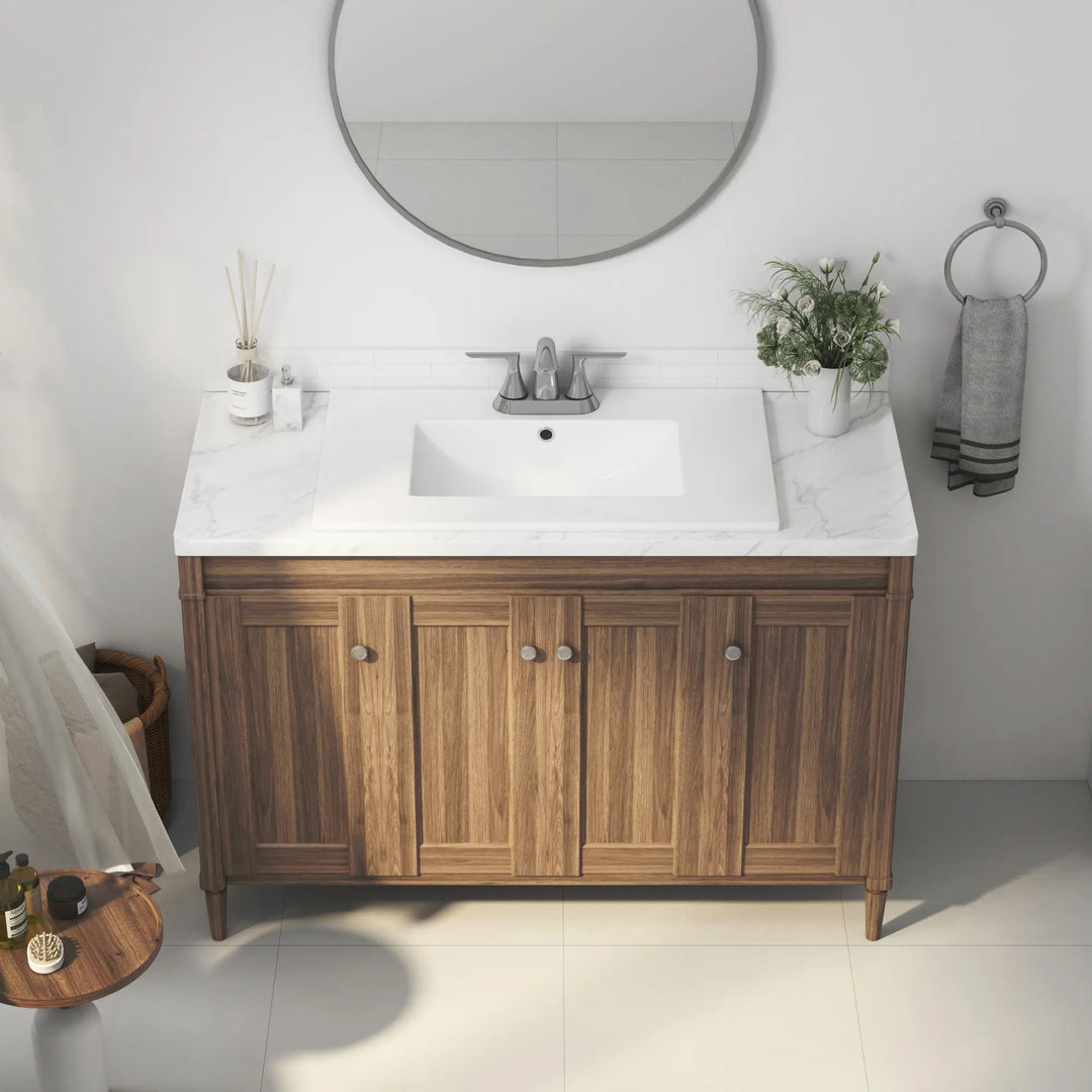 White ceramic rectangular drop-in sink on wood vanity