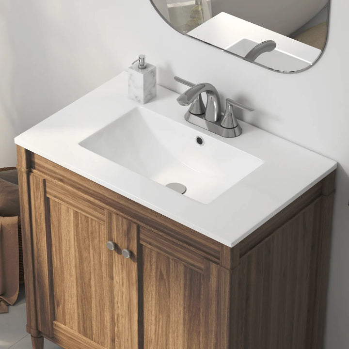 White ceramic integrated sink on wood vanity with faucet