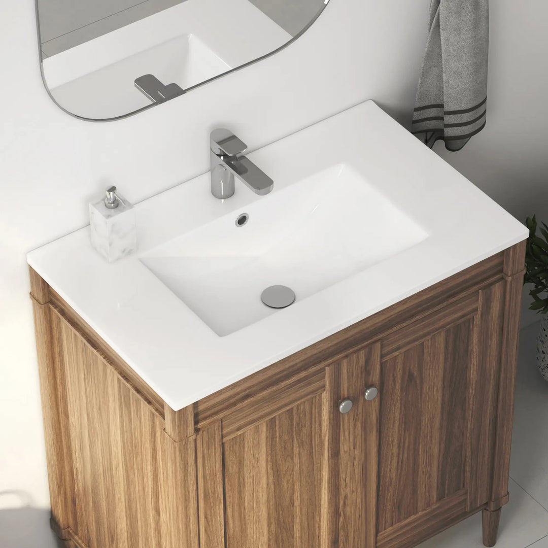 White ceramic integrated sink on wood vanity with faucet