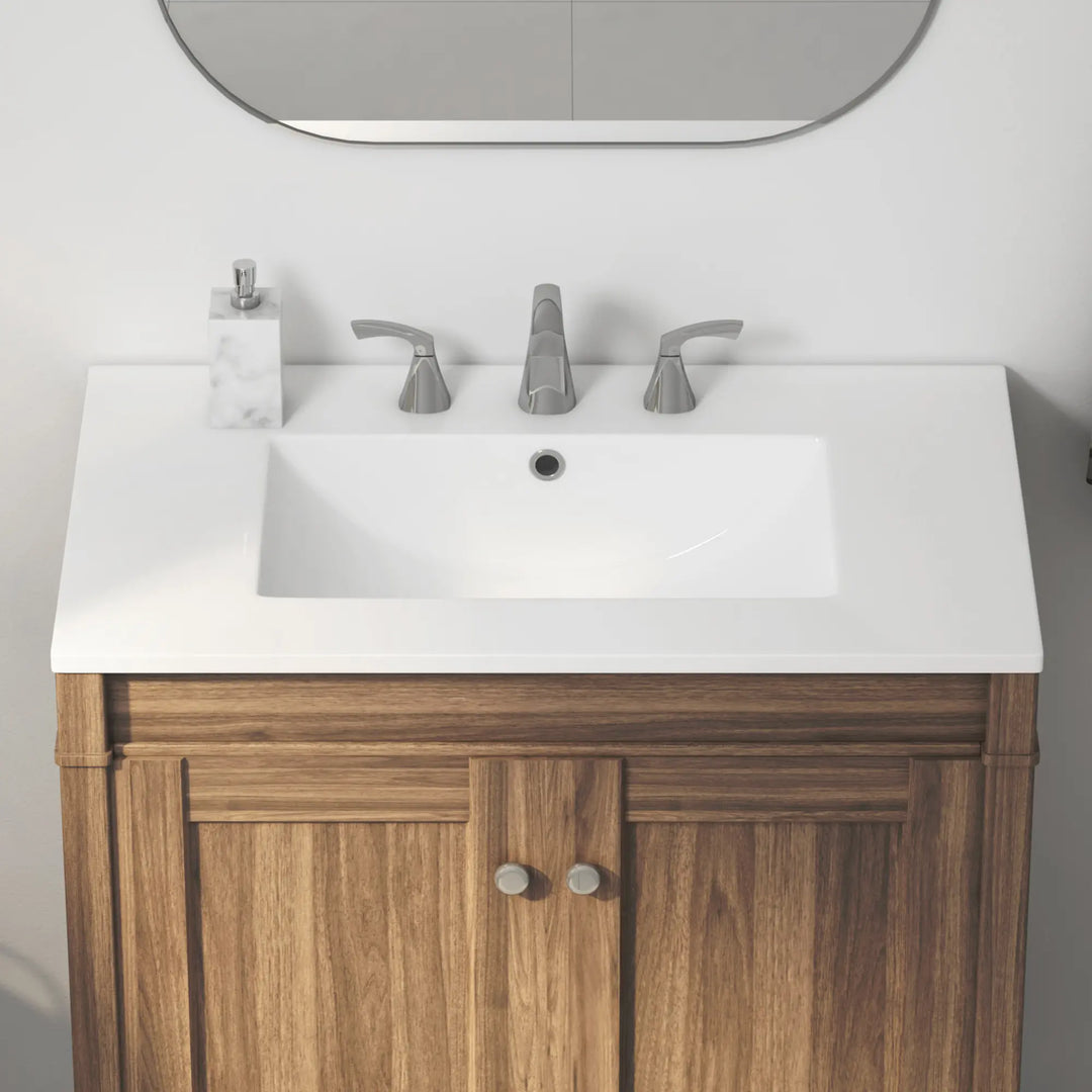 White rectangular ceramic sink with brushed nickel 3-hole faucet and wooden vanity