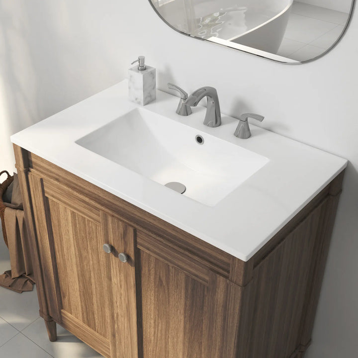White ceramic integrated sink on wood vanity with faucet