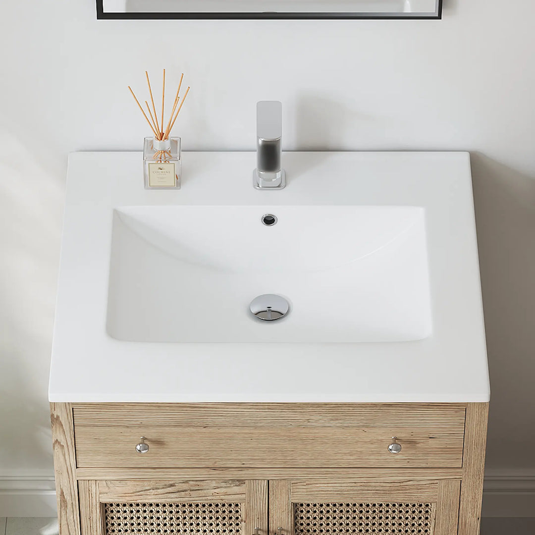 Top view of white rectangular bathroom sink with overflow and faucet.
