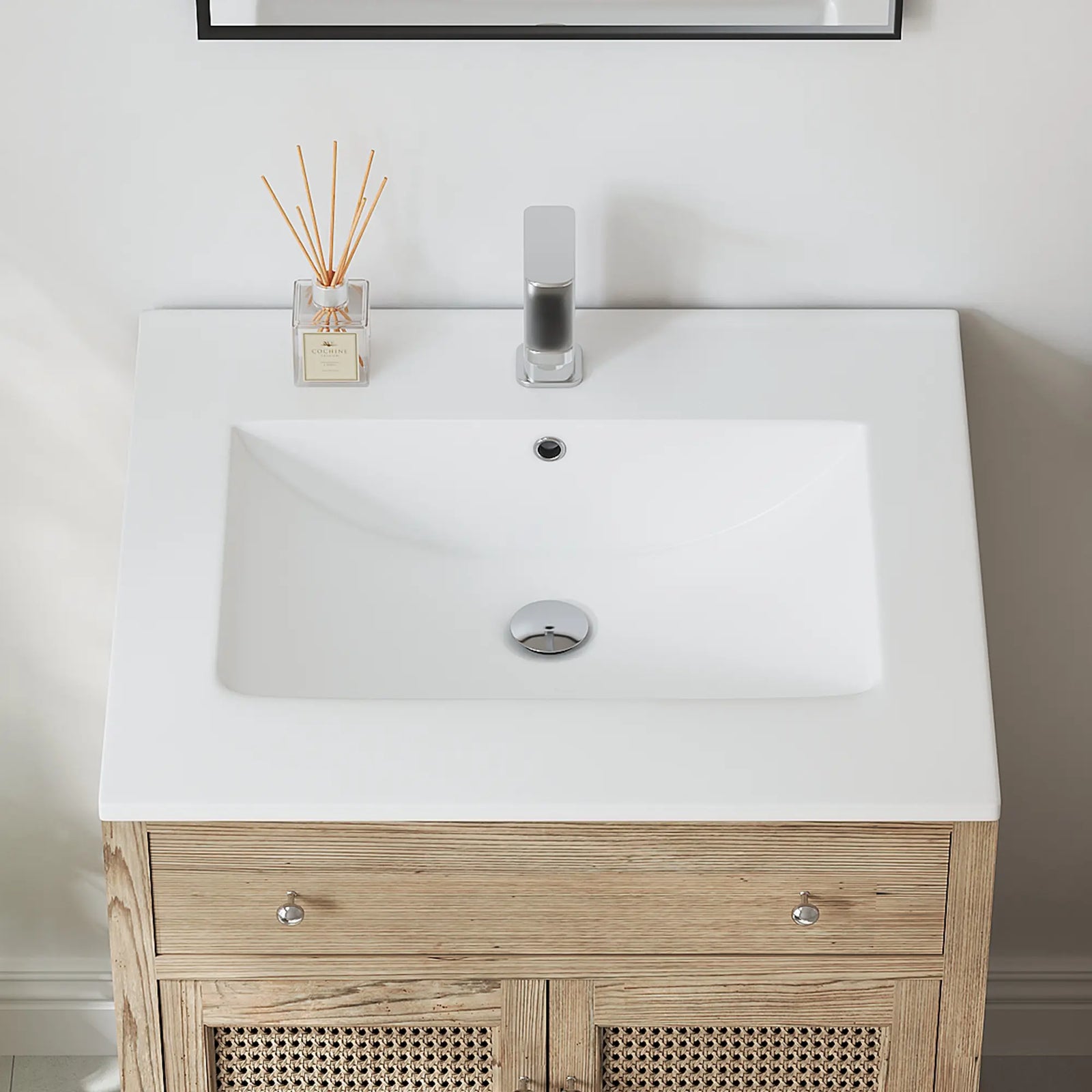 Top view of white rectangular bathroom sink with overflow and faucet.