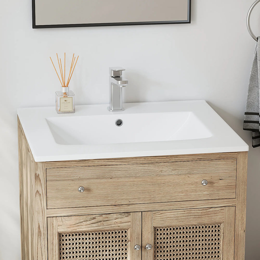 Top view of white rectangular bathroom sink with overflow and faucet.
