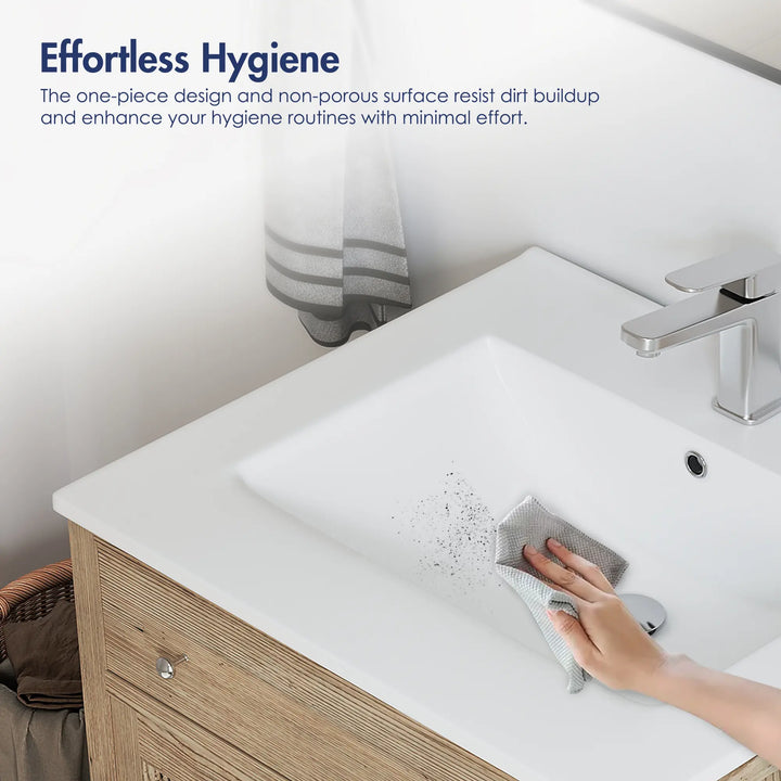 Cleaning non-porous white vanity sink surface with a cloth.