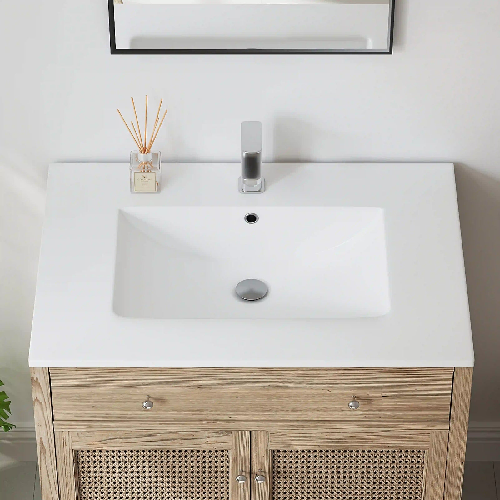 Modern white ceramic sink with light wood vanity cabinet