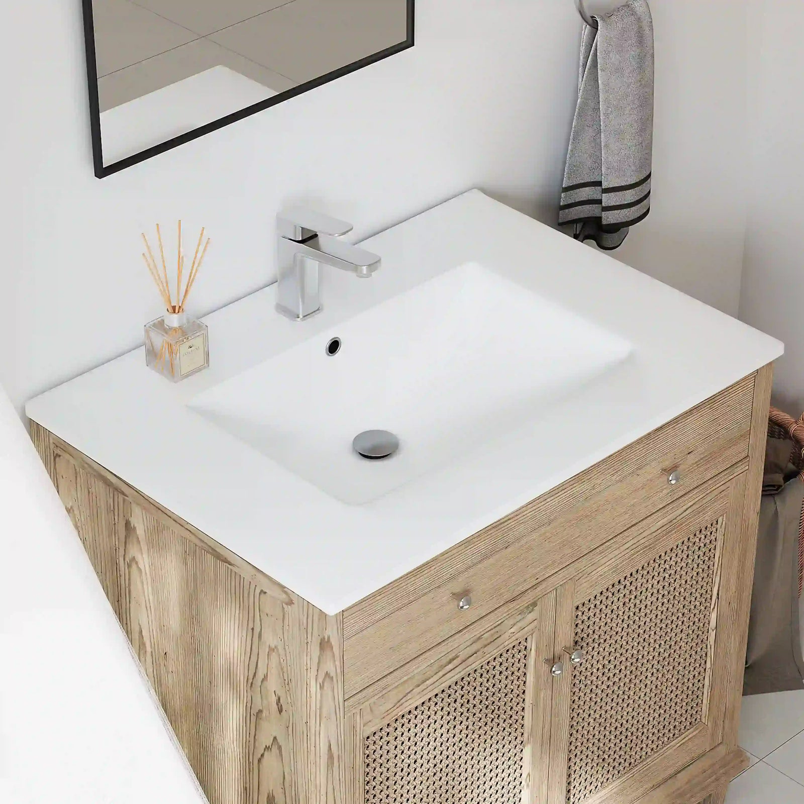 Modern white ceramic sink with light wood vanity cabinet
