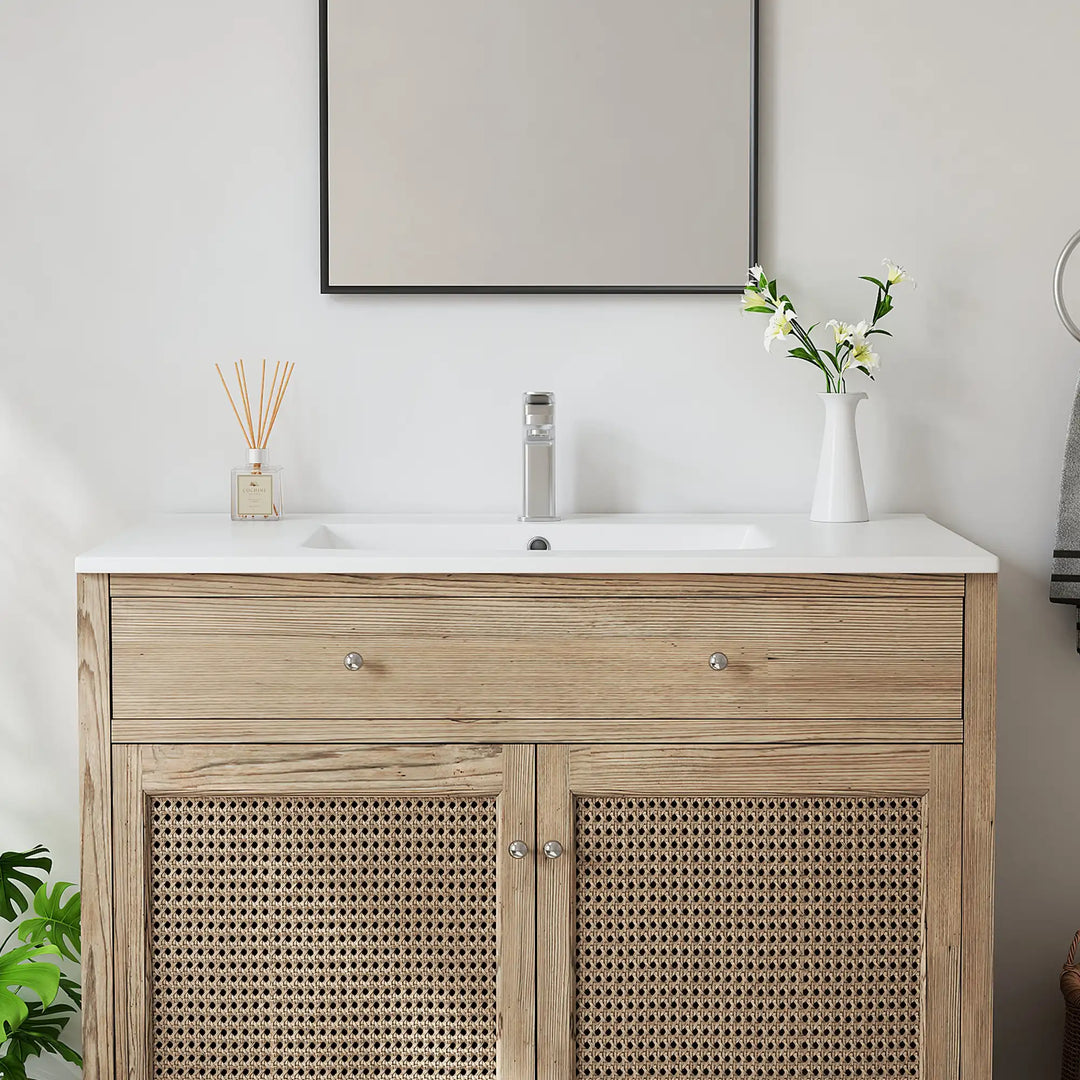 White ceramic integrated sink top and oak wood rattan vanity.
