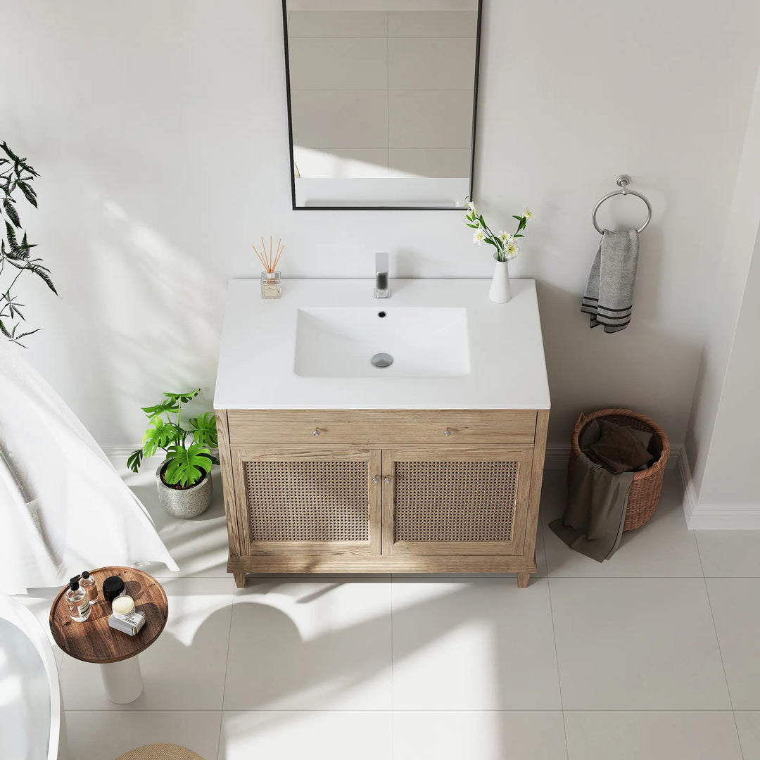 Oak bathroom vanity with rattan cabinet doors and white sink.