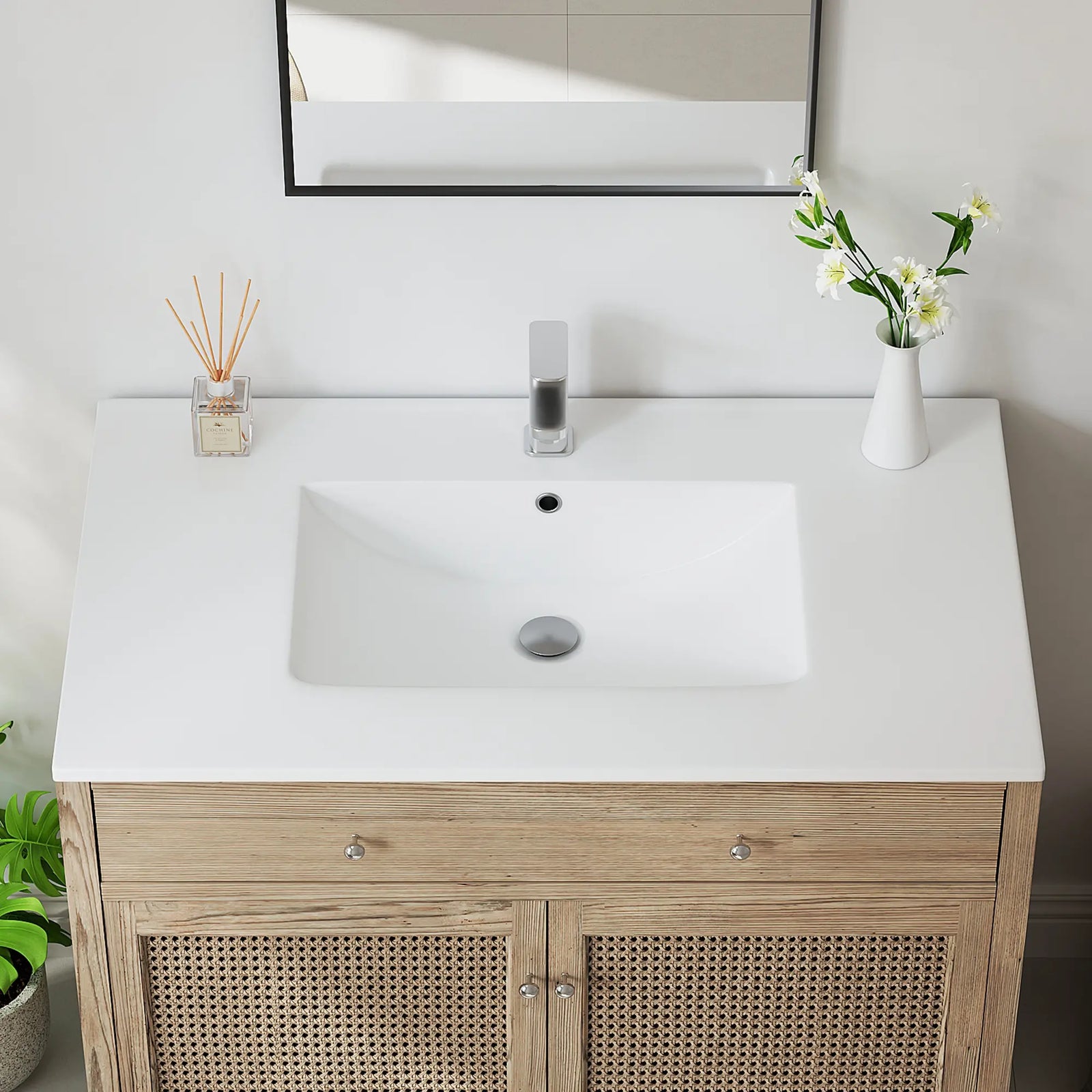 White ceramic integrated sink top and oak wood rattan vanity.