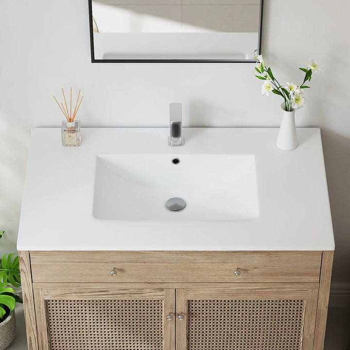 White ceramic integrated sink top and oak wood rattan vanity.