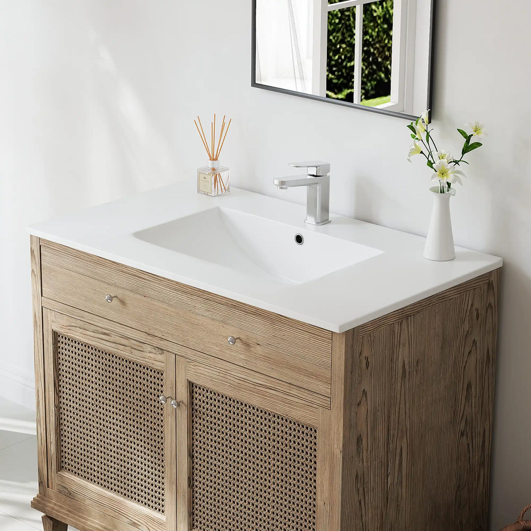 White ceramic integrated sink top and oak wood rattan vanity.