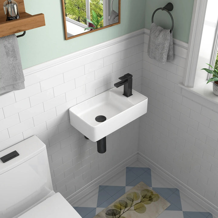 Wall-mounted white ceramic sink with matte black faucet